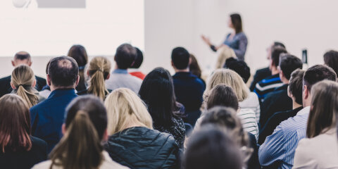 Woman giving presentation on business conference.