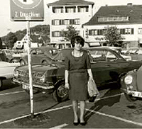 Foto aus dem Flyer zur Wanderausstellung - Foto zeigt eine Frau auf einem Parkplatz