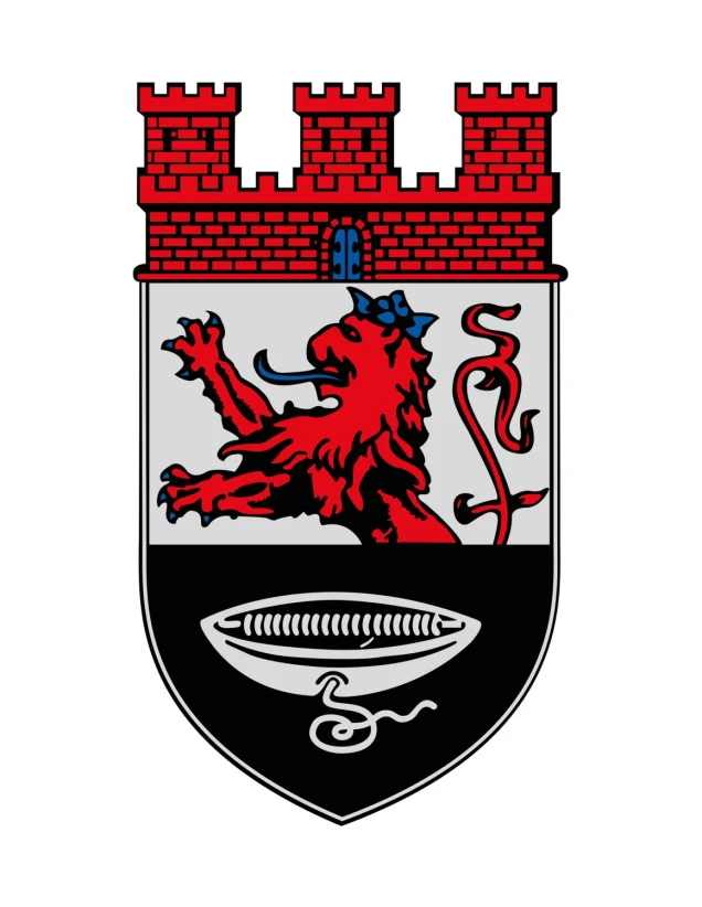 Ein Wappen mit einer roten Zinnenmauer, darunter ein roter Löwe auf silbernem Hintergrund und ein schwarz-silbernes Feld mit einer stilisierten Darstellung eines Fadens und einer Spule.