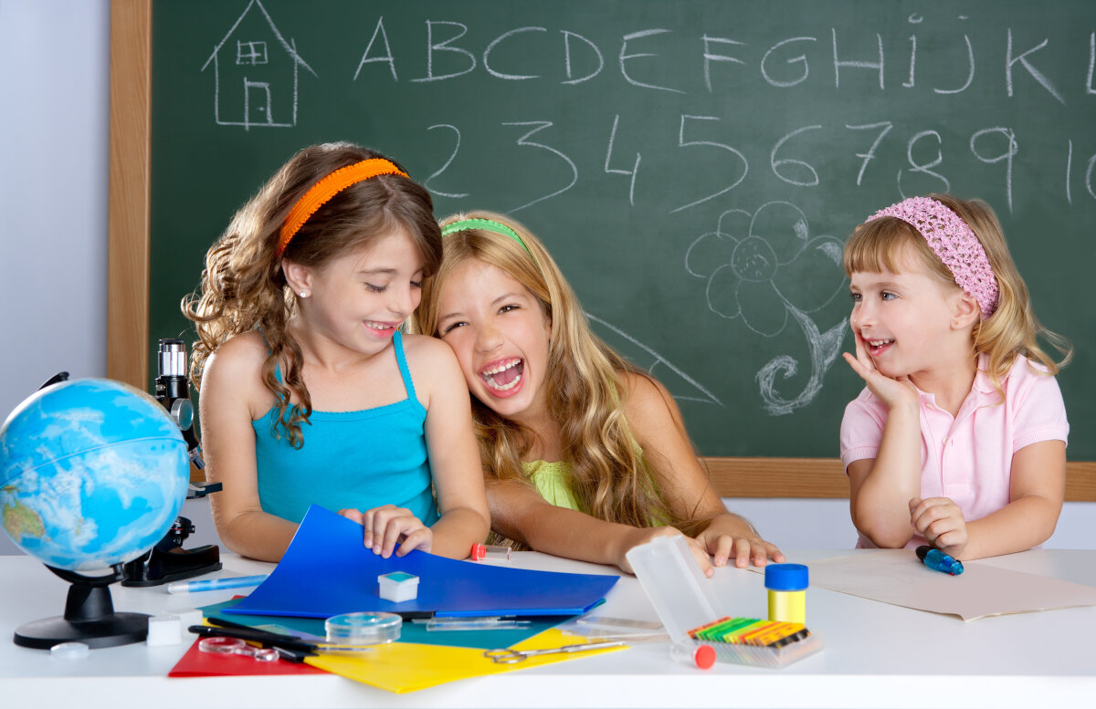 happy laughing kids student girls at school classroom