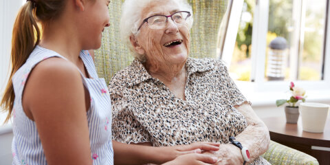Granddaughter Visiting Grandmother In Lounge Of Retirement Home