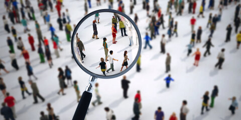 Magnifying glass on a large group of people. 3D Rendering