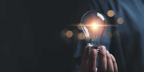 businessman hold light bulb inspired by innovative business idea, male boss or director motivated with successful startup in office, innovation, energy save concept.
