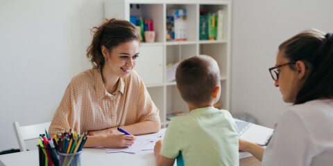 boy having conversation with psychologist for enrollment in school
