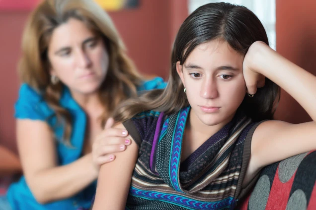 Sad teenage girl and her mother