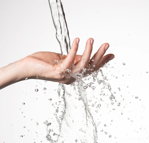 Closeup woman hand under the stream of water