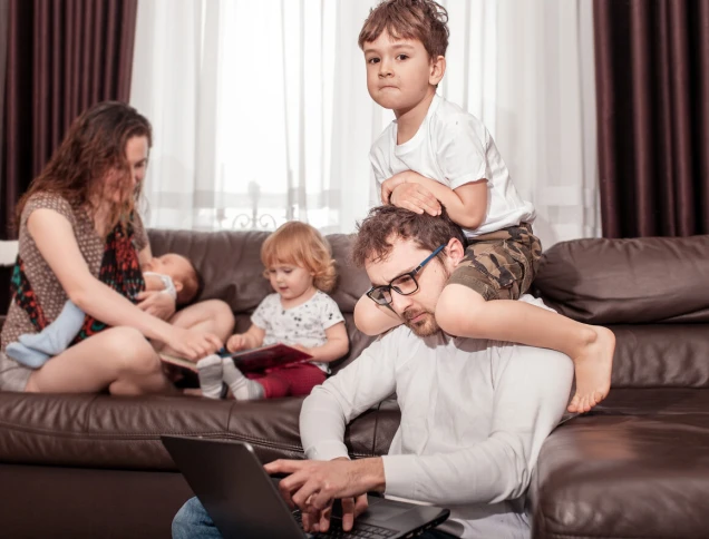 Father works at home. Full family stay home. Father freelancer try to work at home with children.