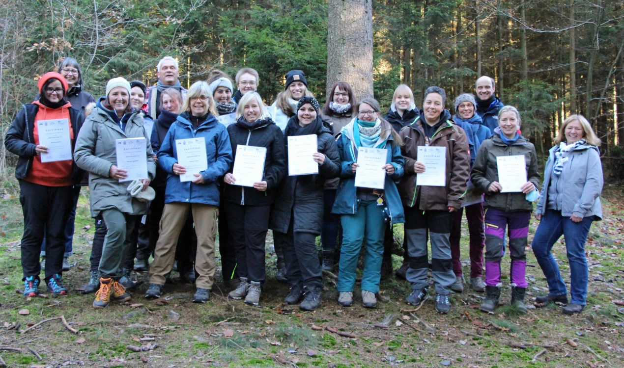 Den 17 neuen Naturerzieherinnen erhielten ihre Zertifikate an ihrem zukünftigen "Arbeitsplatz" im Wald. (V.r.:) Birgit Günther, Kreisjugendamt ; Christine Wosnitza, Biologische Station Oberberg (h.R.l), Dirk Nießing, Ausbildungsleiter und Bernd Freymann, Geschäftsführer der Biologischen Station Oberberg gratulieren den erfolgreichen Absolventinnen. (Foto: OBK)  