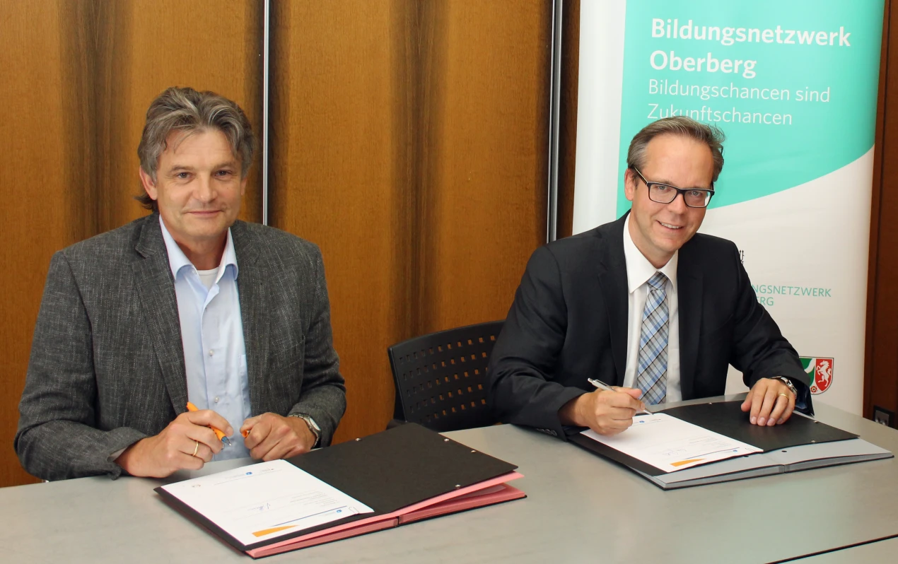 Kreisdirektor Klaus Grootens (r.) und Johannes Schnurr, Leiter der Tranferagentur Kommunales Bildungsmanagement NRW haben den Kooperationsvertrag geschlossen, um die Bildungsarbeit im Oberbergischen zu optimieren (Foto: OBK).